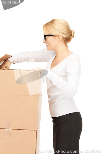 Image of attractive businesswoman with big boxes