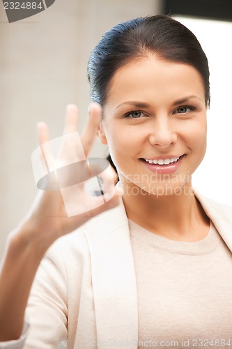 Image of lovely teenage girl showing ok sign