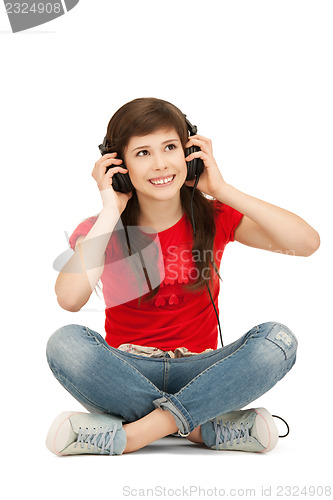 Image of happy teenage girl in big headphones