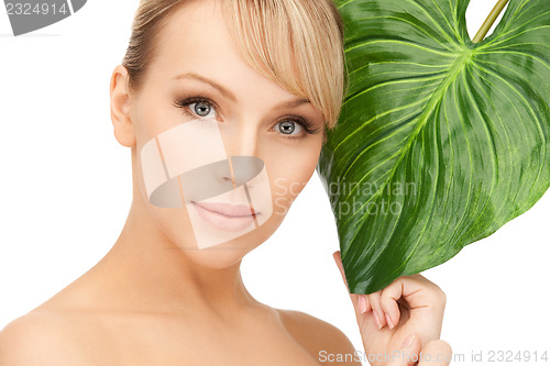 Image of woman with green leaf