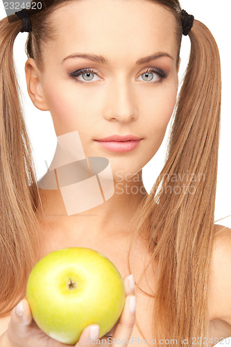 Image of young beautiful woman with green apple