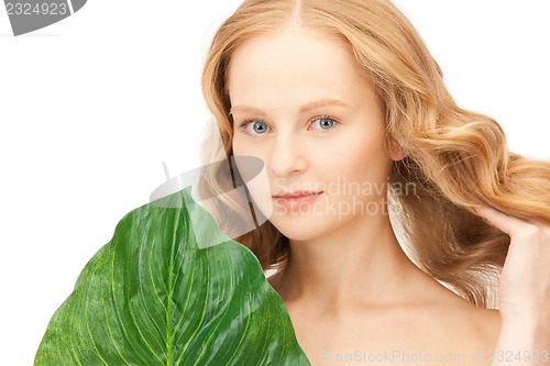 Image of woman with green leaf