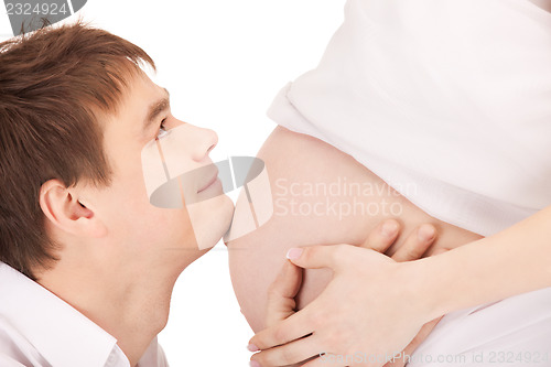 Image of male face and pregnant woman belly