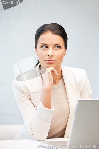Image of pensive woman with laptop computer