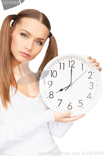 Image of woman holding big clock