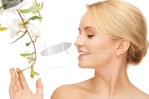 Image of beautiful woman with orchid flower