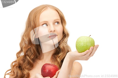 Image of young beautiful woman with green and red apples