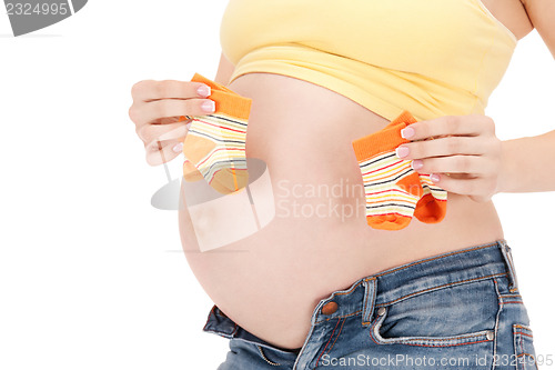 Image of pregnant woman belly and twin socks