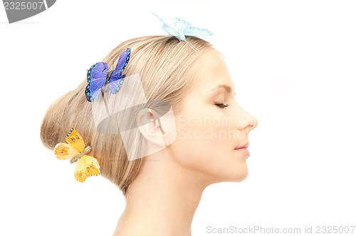 Image of beautiful woman with butterfly in hair