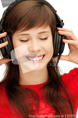 Image of happy teenage girl in big headphones