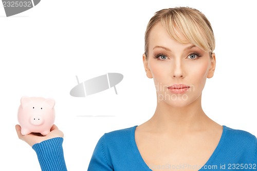 Image of lovely woman with piggy bank