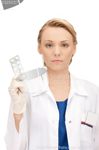 Image of attractive female doctor with pills