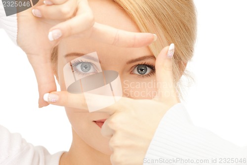 Image of lovely woman creating a frame with fingers