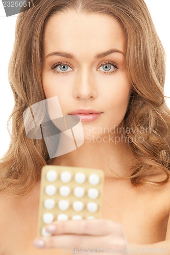 Image of young beautiful woman with pills 