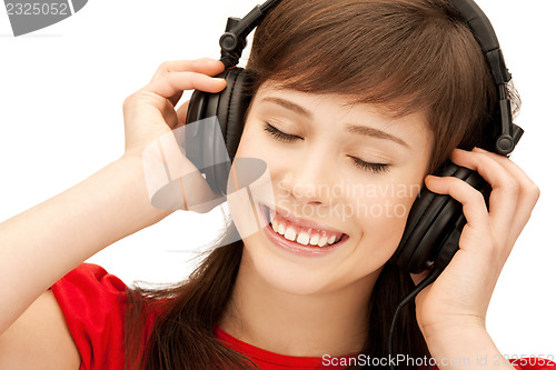 Image of happy teenage girl in big headphones