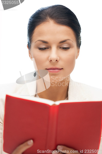 Image of calm and serious woman with book
