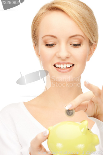 Image of lovely woman with piggy bank and money