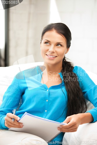 Image of happy woman with big notepad