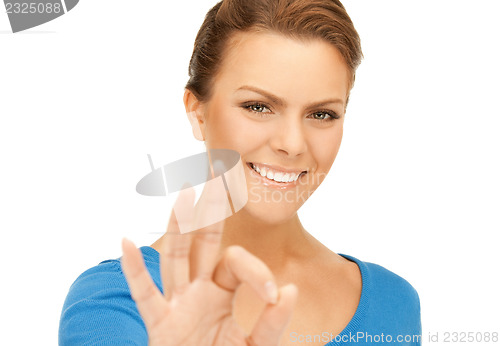 Image of lovely teenage girl showing ok sign