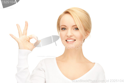 Image of lovely teenage girl showing ok sign