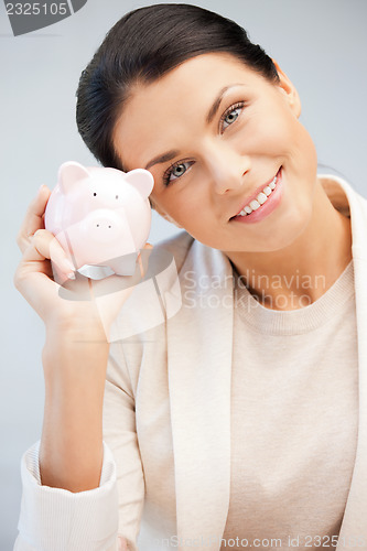 Image of lovely woman with piggy bank