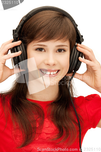 Image of happy teenage girl in big headphones