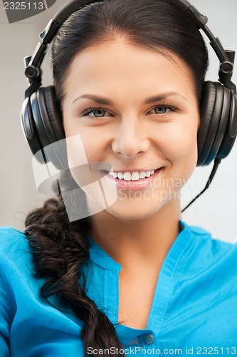 Image of happy teenage girl in big headphones