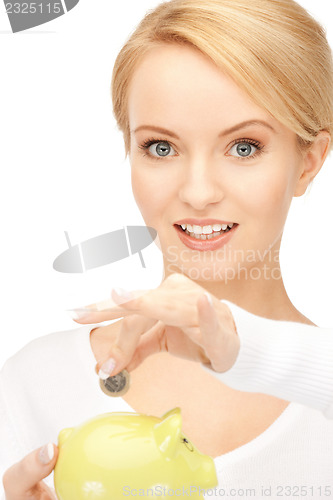 Image of lovely woman with piggy bank and money