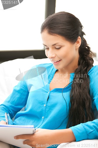 Image of happy woman with big notepad