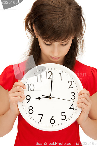 Image of teenage girl holding big clock