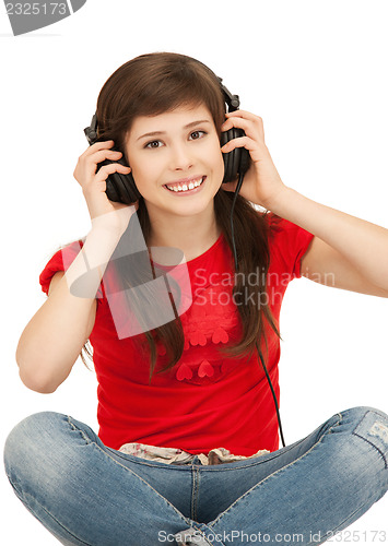 Image of happy teenage girl in big headphones
