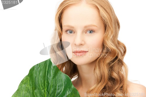 Image of woman with green leaf