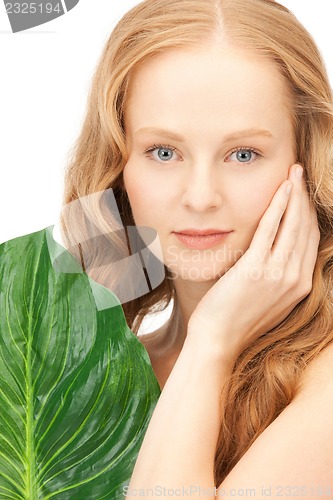 Image of woman with green leaf