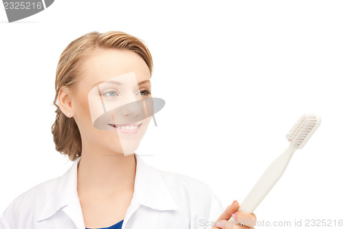 Image of doctor with toothbrush