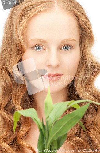 Image of woman with green sprout