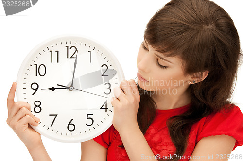 Image of teenage girl holding big clock