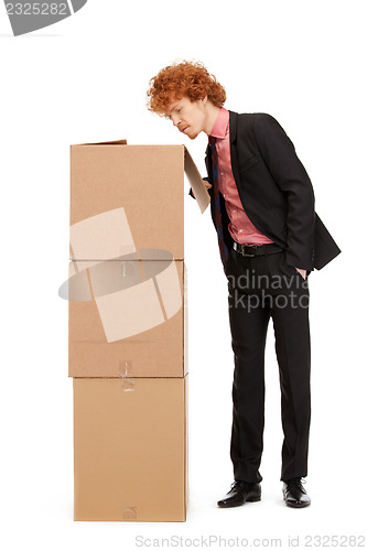 Image of attractive businessman with big boxes