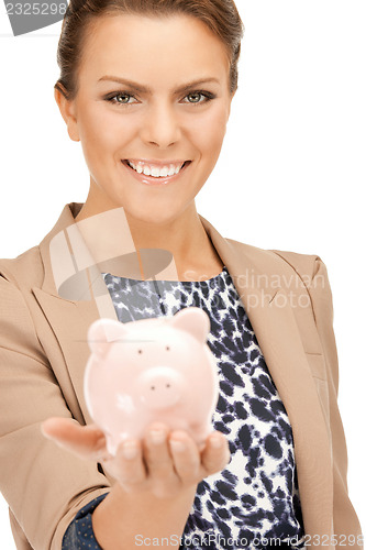 Image of lovely woman with piggy bank