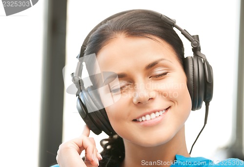 Image of happy teenage girl in big headphones