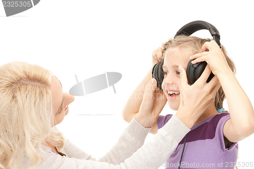 Image of mother and little girl with headphones