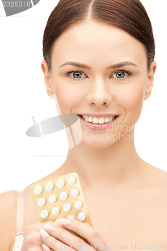 Image of young beautiful woman with pills