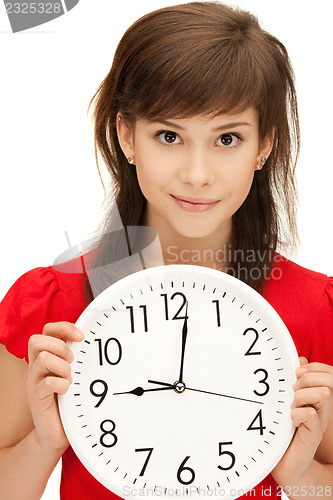 Image of teenage girl holding big clock