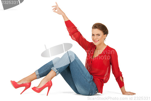 Image of lovely woman in red blouse and jeans