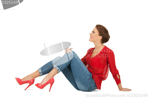 Image of lovely woman in red blouse and jeans