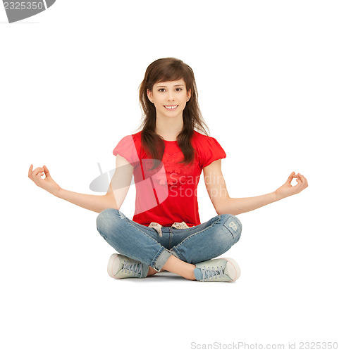 Image of happy and carefree teenage girl in lotus pose