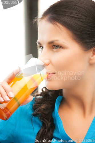 Image of beautiful woman with glass of juice