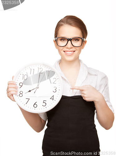 Image of woman holding big clock