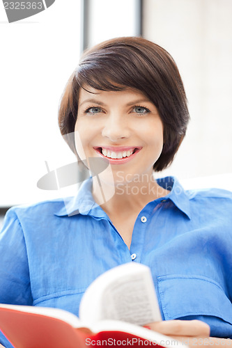 Image of happy and smiling woman with book