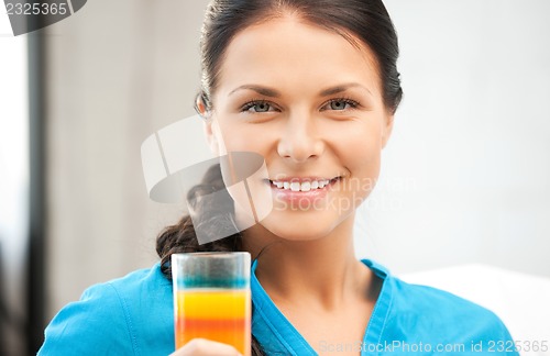 Image of beautiful woman with glass of juice
