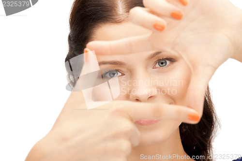 Image of lovely woman creating a frame with fingers